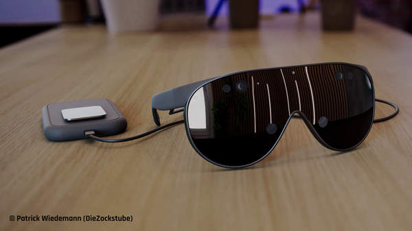Rendergrafik von schwarzer XR-Brille mit externer Recheneinheit auf Schreibtisch.