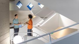 Two people talking in a staircase