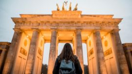 A person standing in front of the Brandenburg Gate