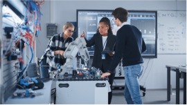 Three coworkers around a table with lab equipment