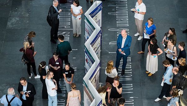 Eröffnung der Ausstellung "Poster im Bundestag: Wissenschaftsfreiheit - die Freiheit zu forschen" in der Halle des Paul-Löbe-Hauses: Blick auf Besucherinnen und Besucher in der Ausstellung.