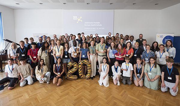 Gruppenbild von Festakt des 20jährigen Jubiläums des Programms "Europa macht Schule". Die Teilnehmer stehen zusammen und lächeln in die Kamera.